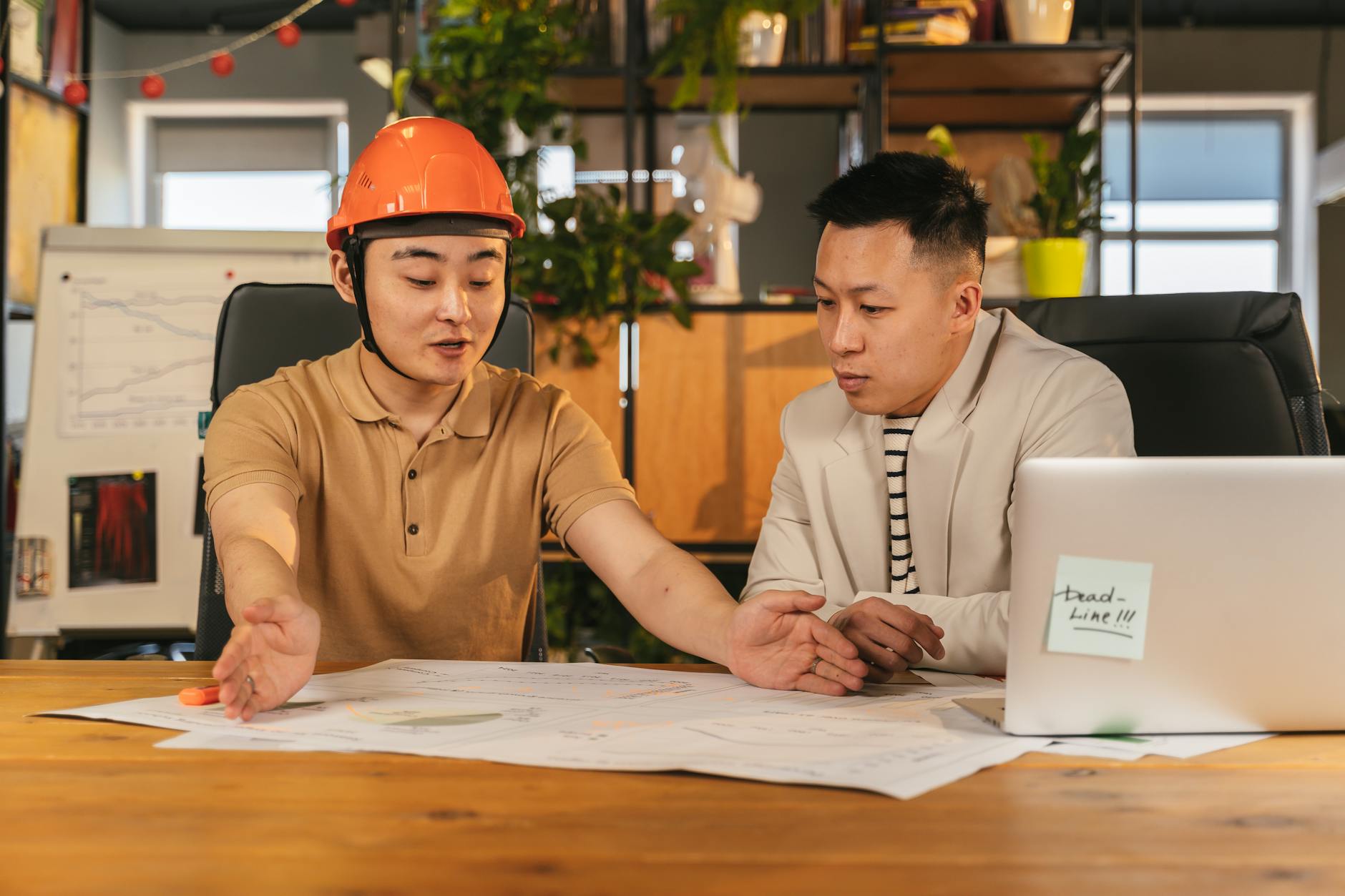 Two engineers reviewing system architecture and project plans