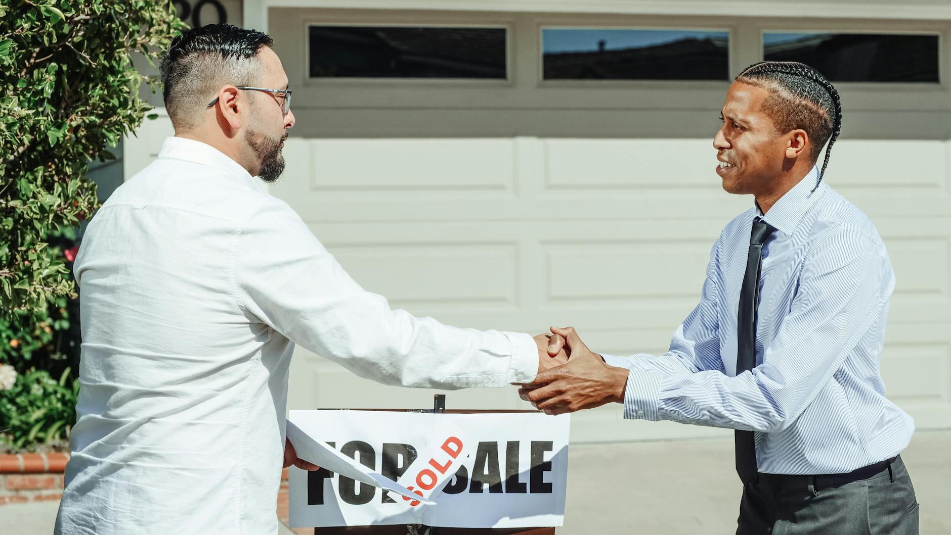 Two men shaking hands, sealing a business agreement.